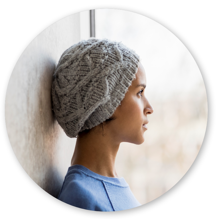 Woman cancer survivor with knit cap